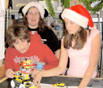 IT WORKS – Munchkins teammates Adam Spierer, Roxanne Harmon and Stephanie Schaeberle practice manuevers for the FIRST Lego League’s competition. Not pictured is member Kevin Walch. (Courtesy Photo)