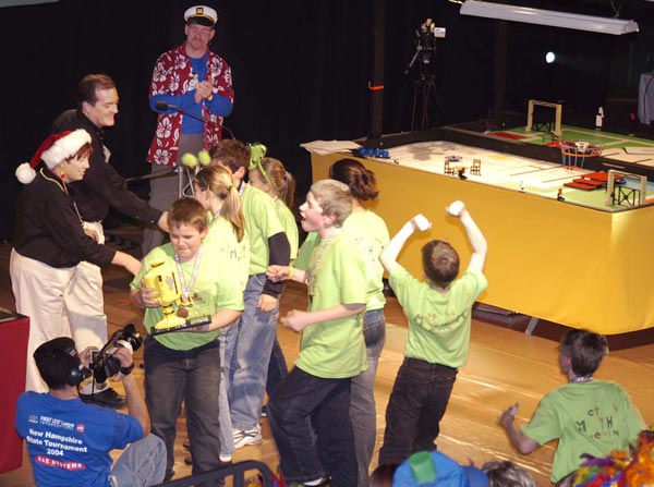 WE DID IT! – Mindstorms Mayhem members Nathan Streeter of
Bedford; David Schunemann and Jean Marc Le Doux of Hollis; Katie
Hammes, Melissa Gray and Nicholas Hammes of Milford; Victoria
Umenhofer and Dan Umenhofer of Wilton; Ryan Simard of Lyndeborough;
and Amelia Jennings of Merrimack receive the Director's Award trophy
at the New Hampshire State FIRST Lego League Tournament on Dec
11. (Courtesy Photo)